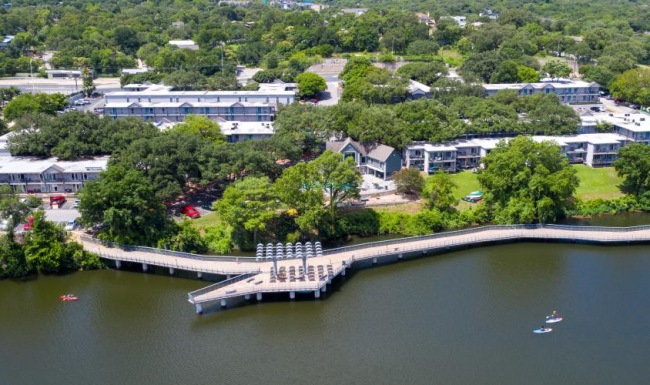 A perfect fit for the whole family a bridge over a river with buildings and trees around it