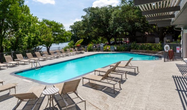 Sparkling swimming pool a swimming pool with chairs around it